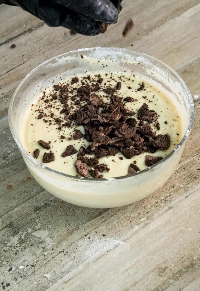Adding crushed Oreo cookies to pancake batter