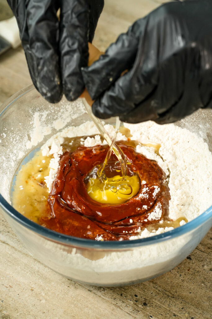 Adding egg to pizza muffin batter