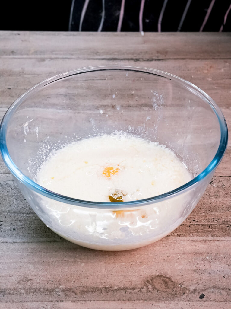 Adding eggs to milk for red velvet pancake recipe