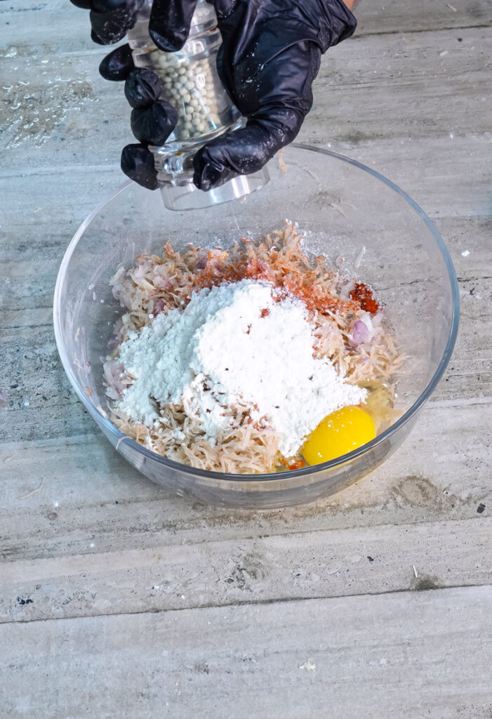 Adding flour to German potato pancake mixture