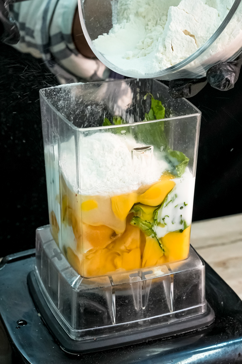 Adding flour to banana spinach pancake batter in blender