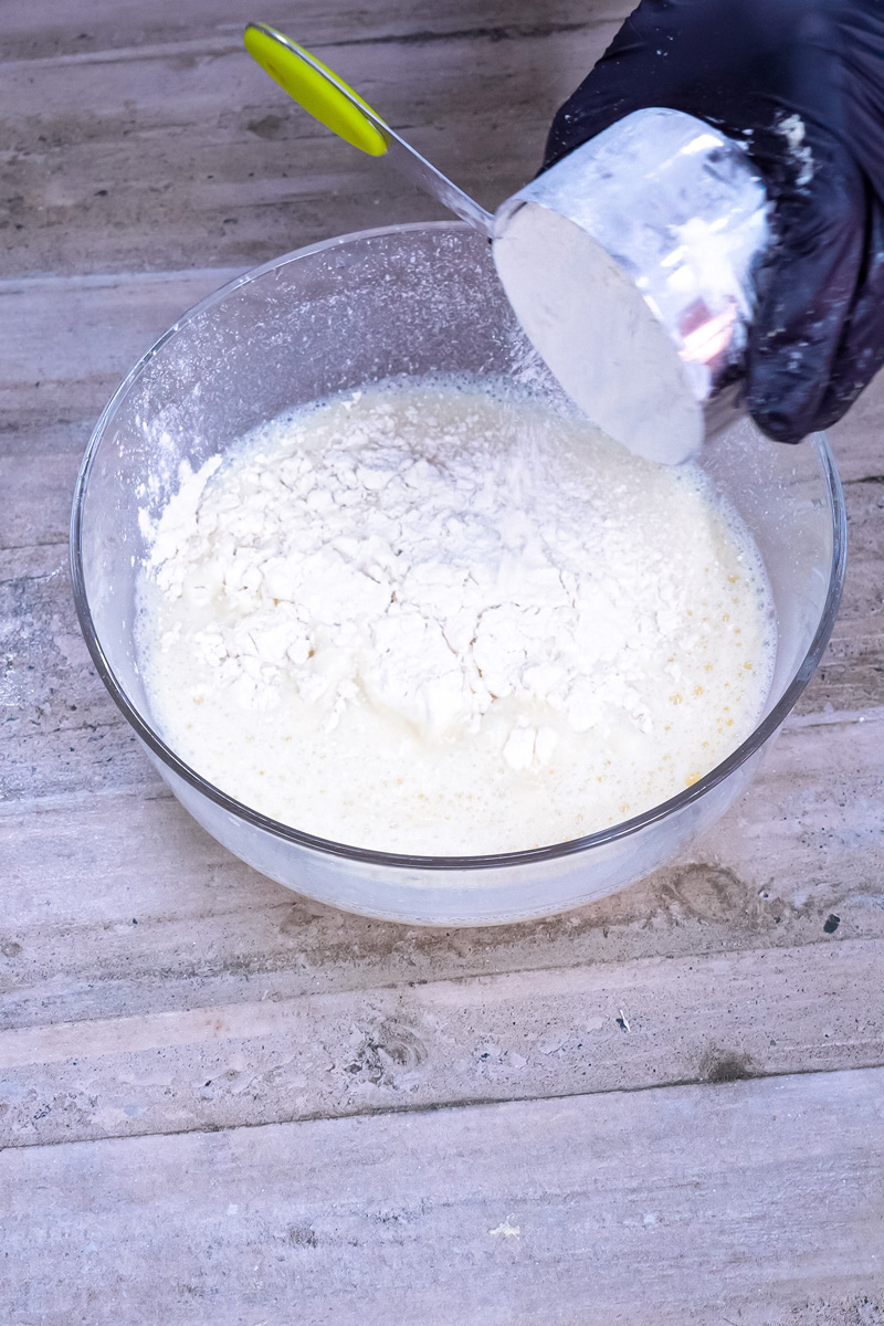 Adding flour to egg and milk mixture for German pancake batter