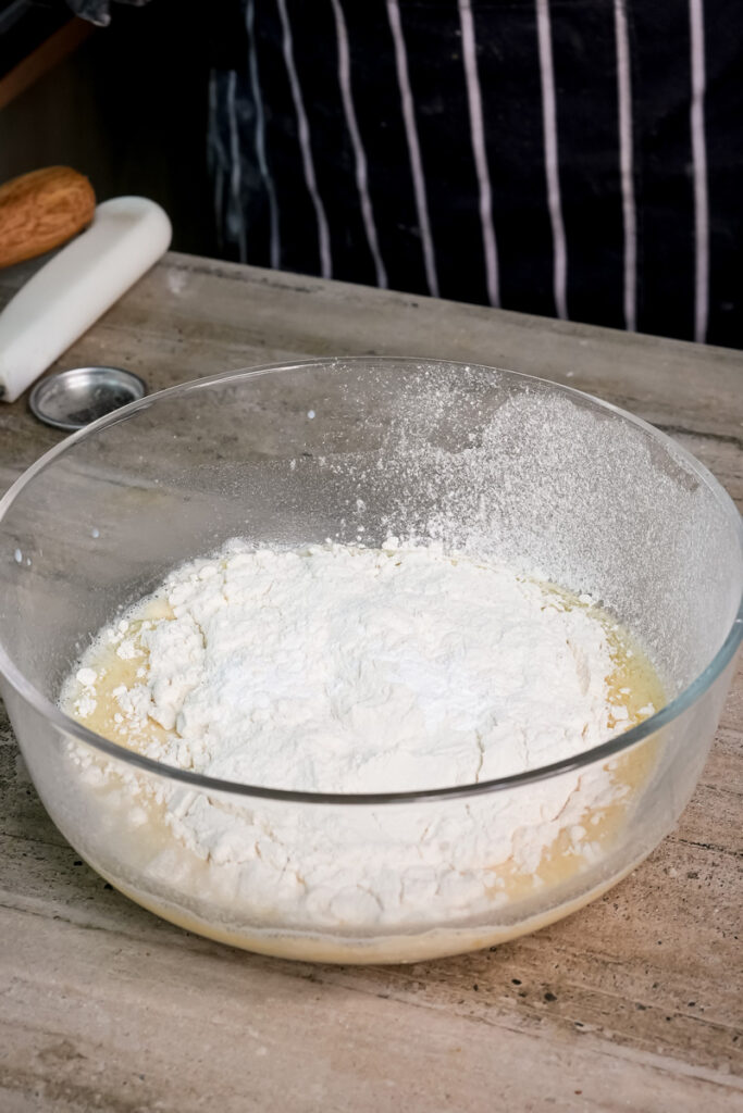 Adding flour to wet ingredients for apple cinnamon pancakes