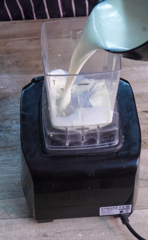 Adding milk to Dutch baby pancake batter