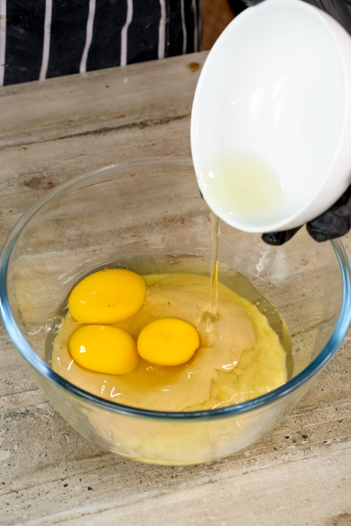 Adding milk to peanut butter banana muffin batter