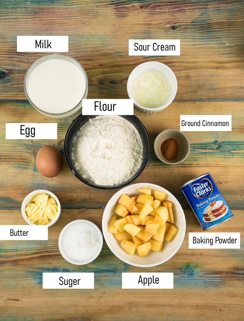 Apple cinnamon pancake ingredients laid out on wooden surface