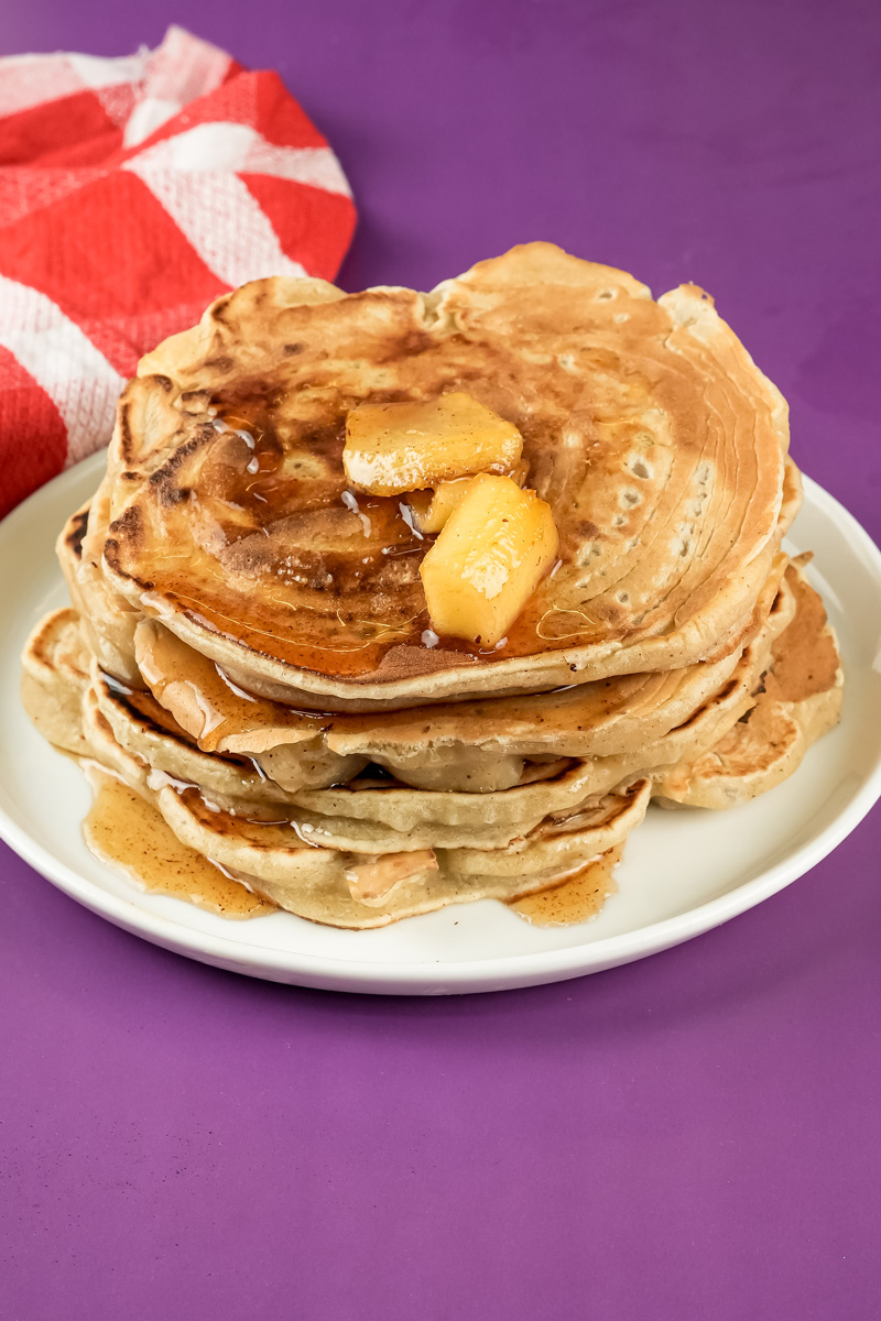 Apple cinnamon pancakes topped with butter and syrup
