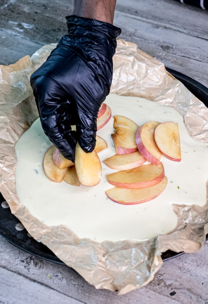 Arranging apple slices on unbaked German Apple Pancake