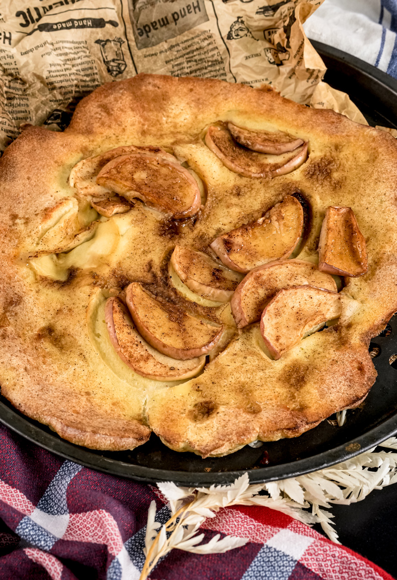 Baked German Apple Pancake with caramelized apples in cast iron skillet