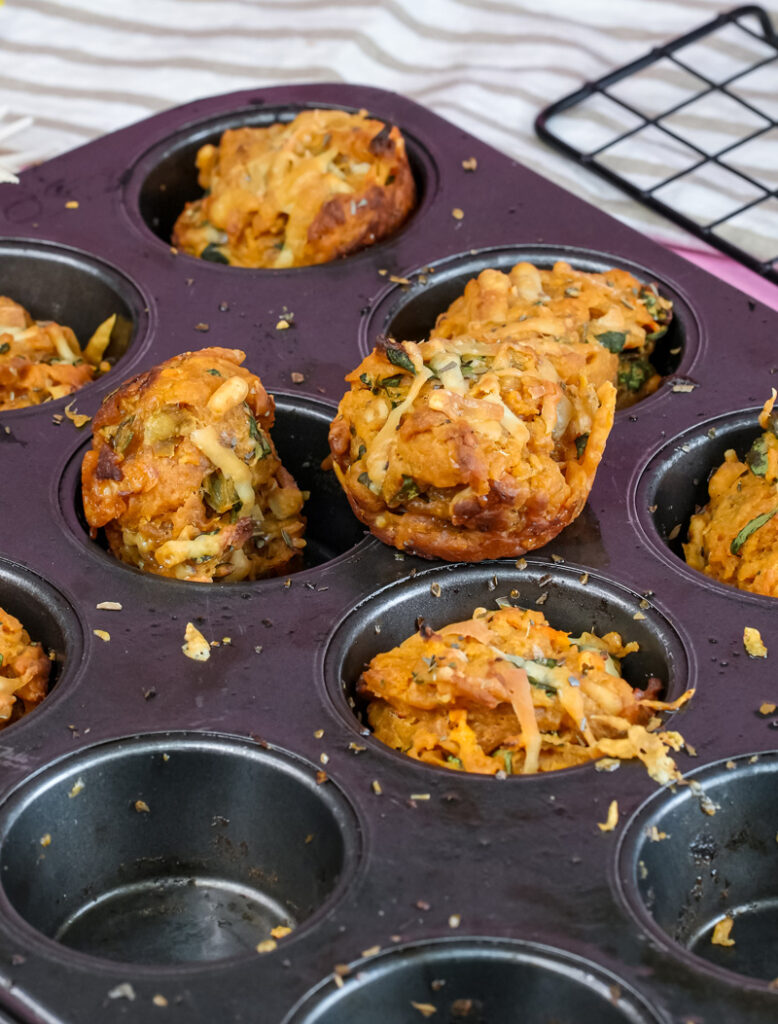 Baked pizza muffins with melted cheese in muffin tin