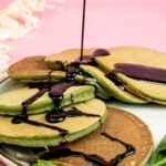 Banana spinach pancakes drizzled with chocolate sauce