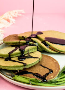 Banana spinach pancakes drizzled with chocolate sauce