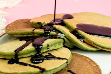 Banana spinach pancakes drizzled with chocolate sauce