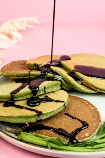 Banana spinach pancakes drizzled with chocolate sauce