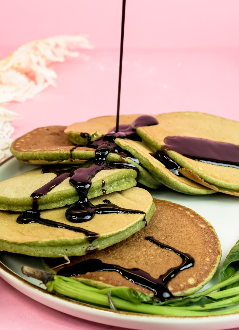 Banana spinach pancakes drizzled with chocolate sauce