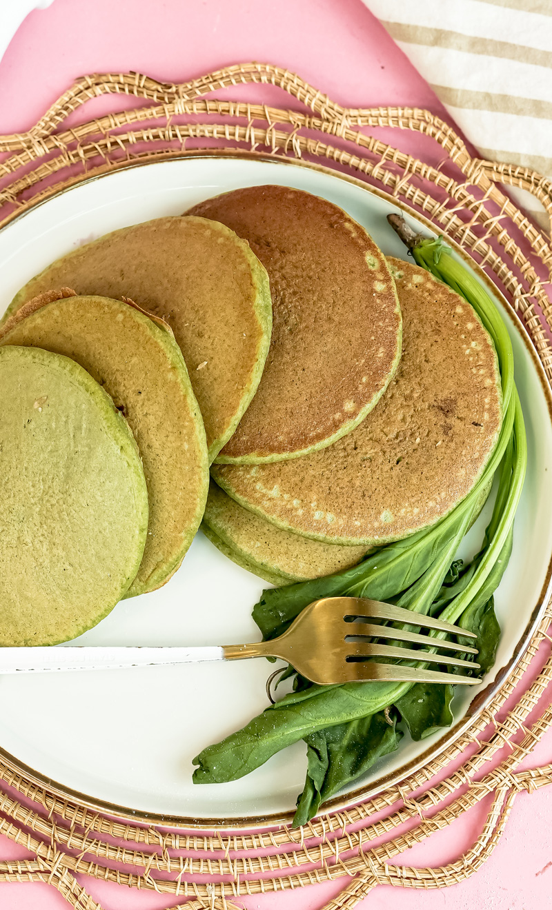 Banana spinach pancakes on decorative plate with gold fork