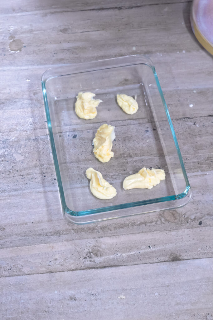 Butter pieces in baking dish ready for German pancakes