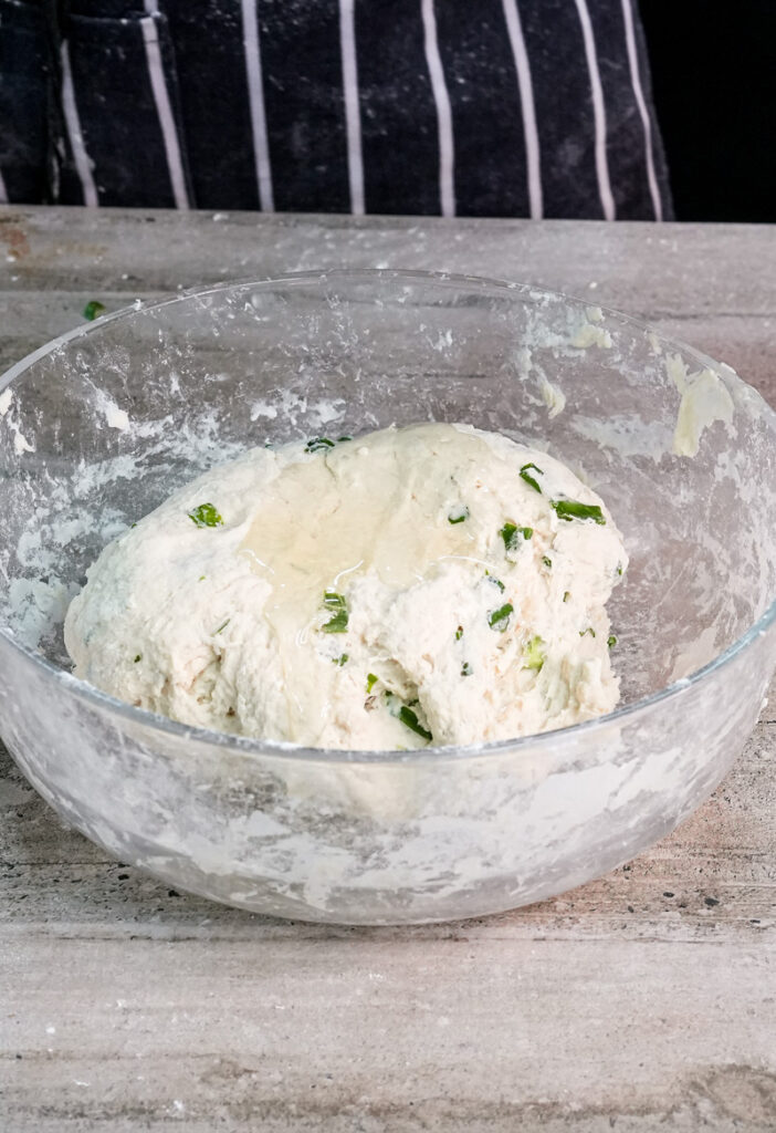 Formed Chinese scallion pancake dough ball in mixing bowl
