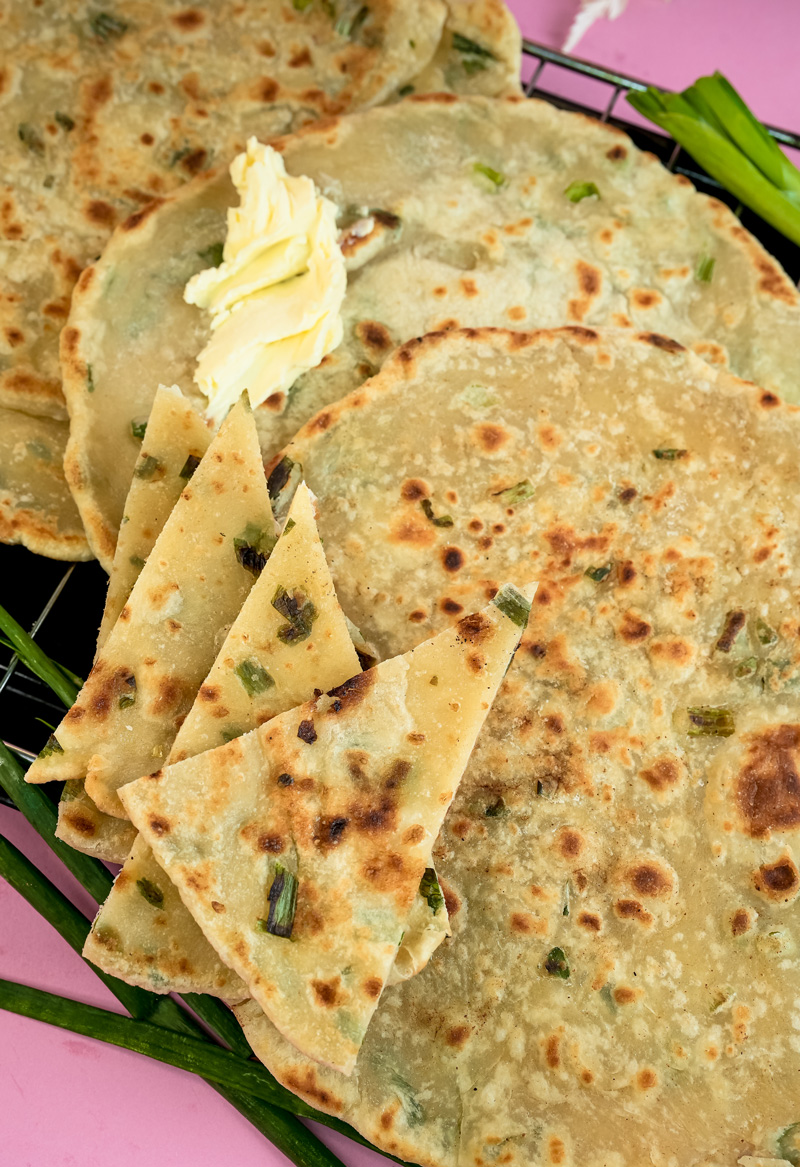 Detail shot of Chinese scallion pancakes with green onion bits
