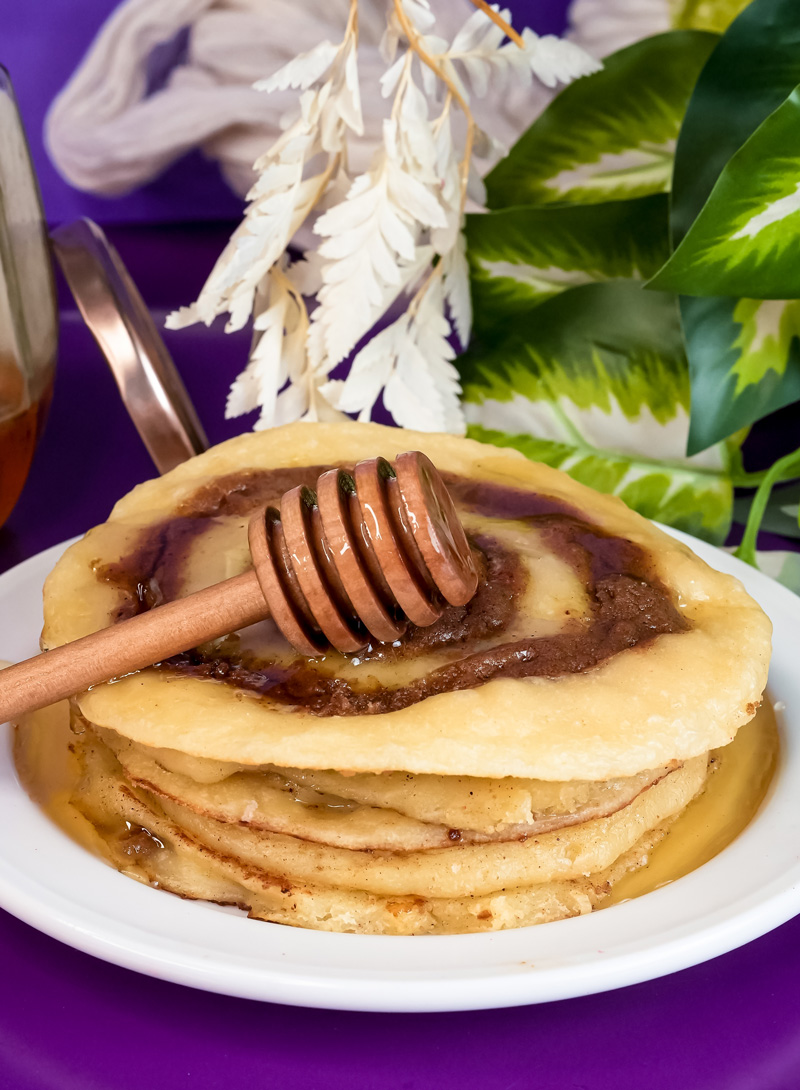 Final presentation of cinnamon roll pancakes with honey and decorative honey dipper