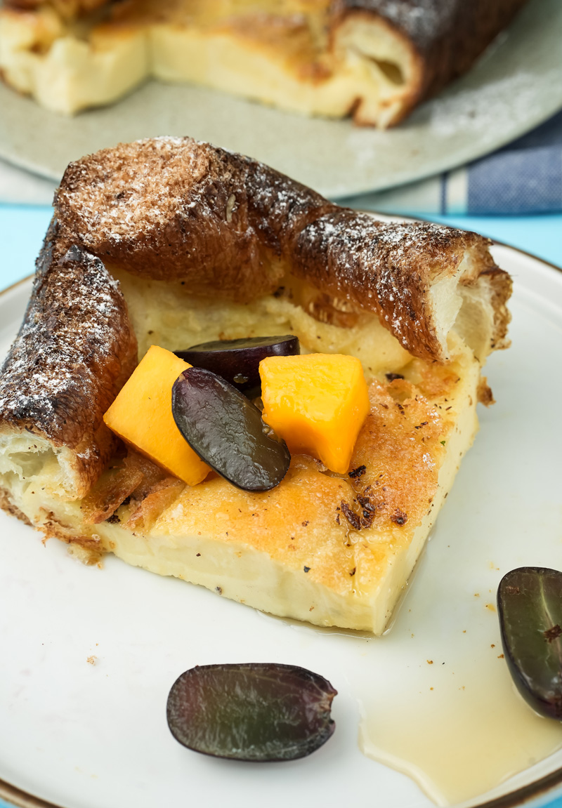 Close-up of German pancake slice with colorful fruit toppings