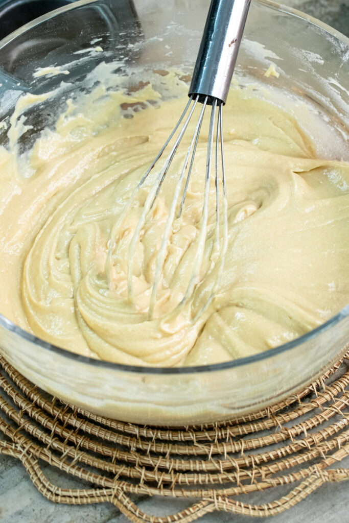 Continuing to whisk mini chocolate chip muffin mixture