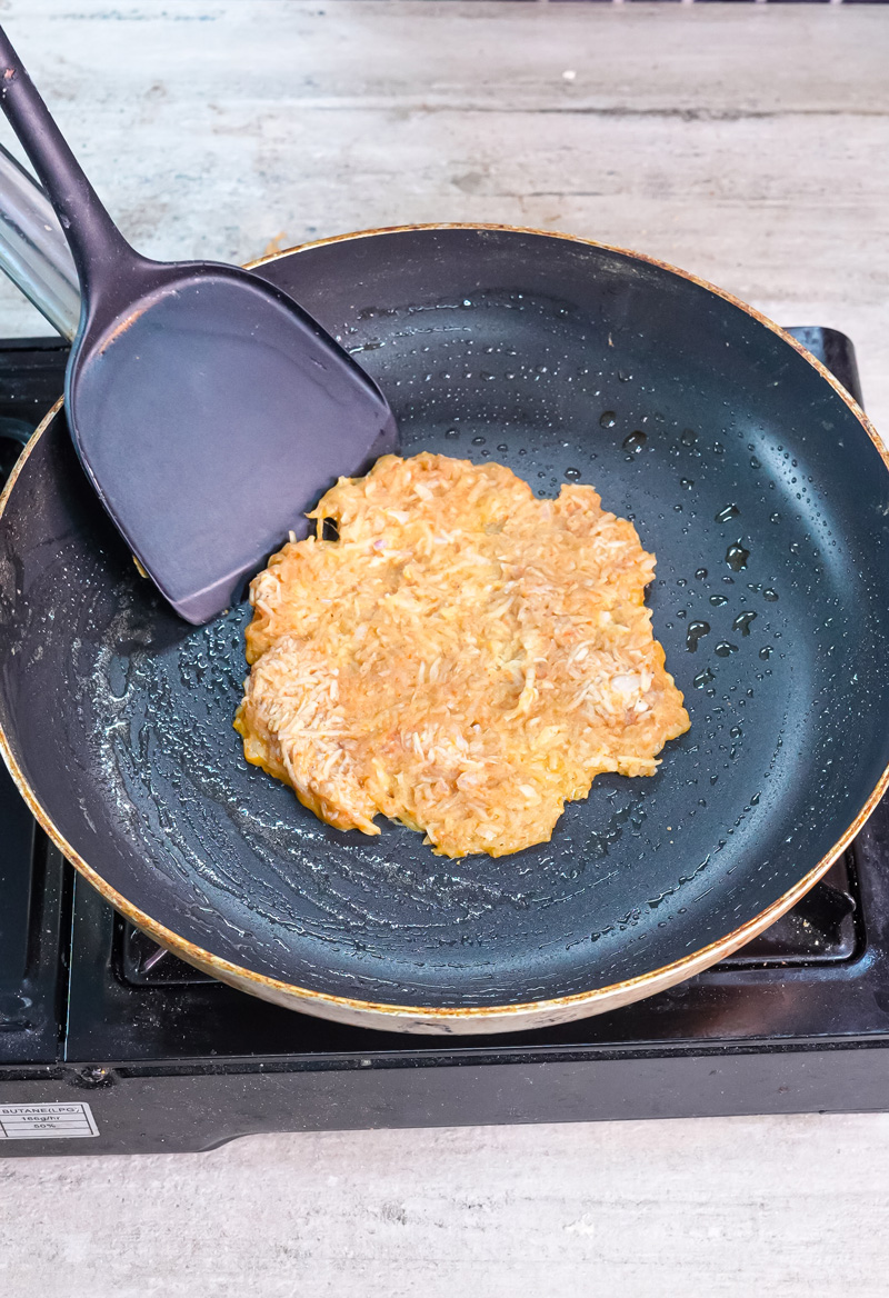 Cooking German potato pancake in non-stick pan