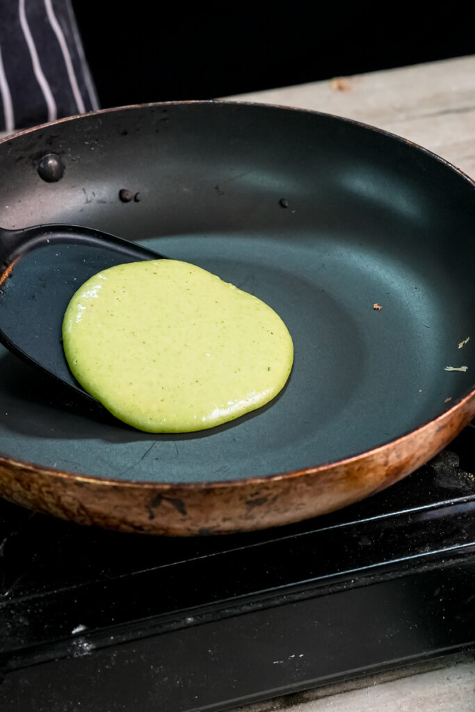Cooking banana spinach pancake in non-stick pan