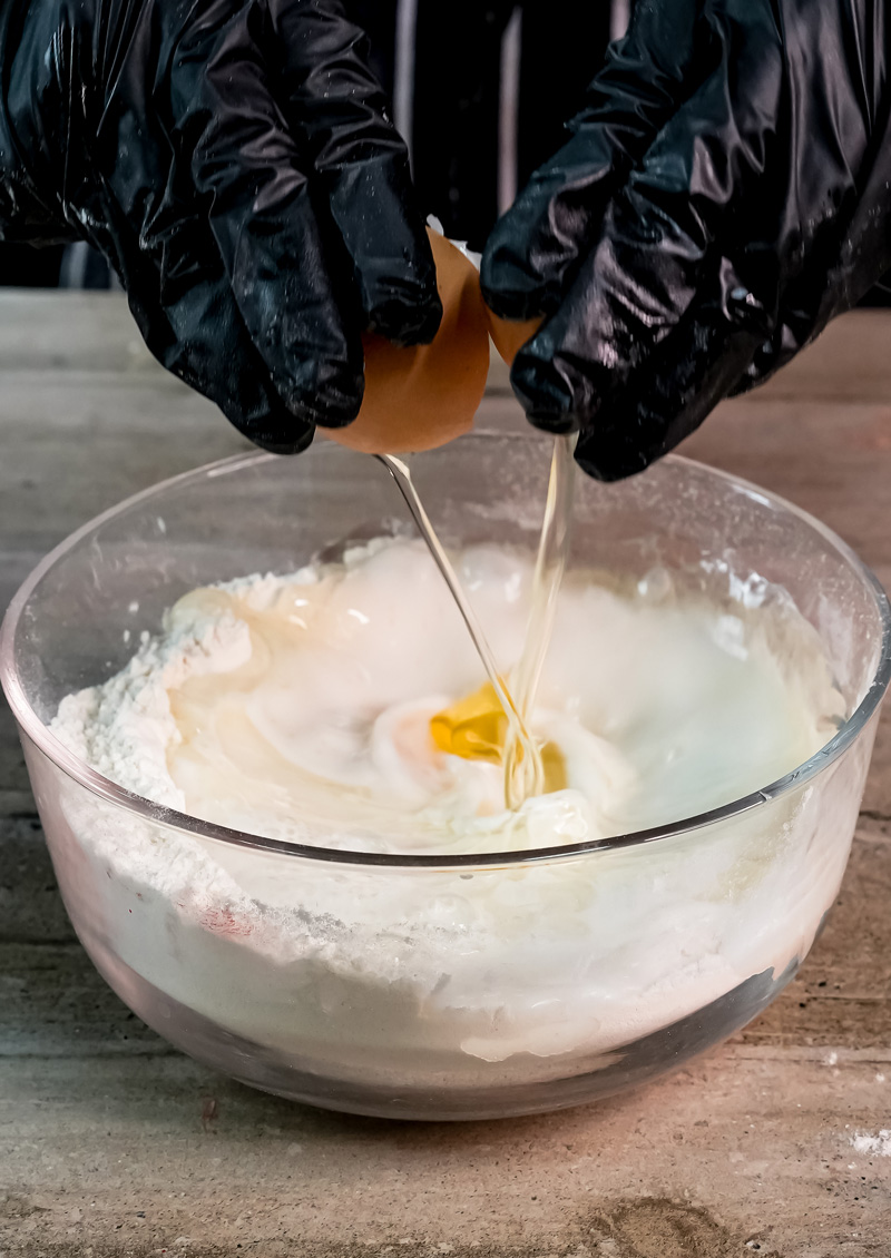 Cracking eggs into gluten-free pancake batter