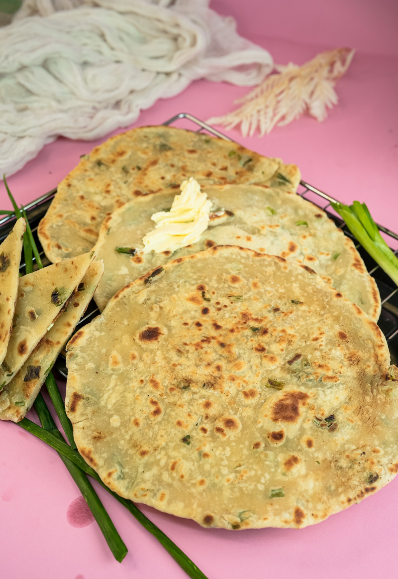 Crispy homemade scallion pancakes with visible green onion pieces