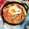 Dutch baby pancake with chicken, egg, tomatoes and fresh herbs