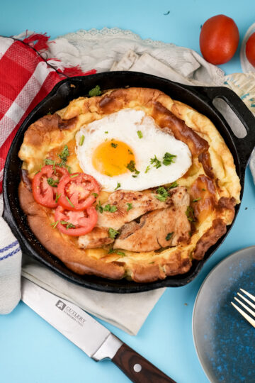 Dutch baby pancake with chicken, egg, tomatoes and fresh herbs
