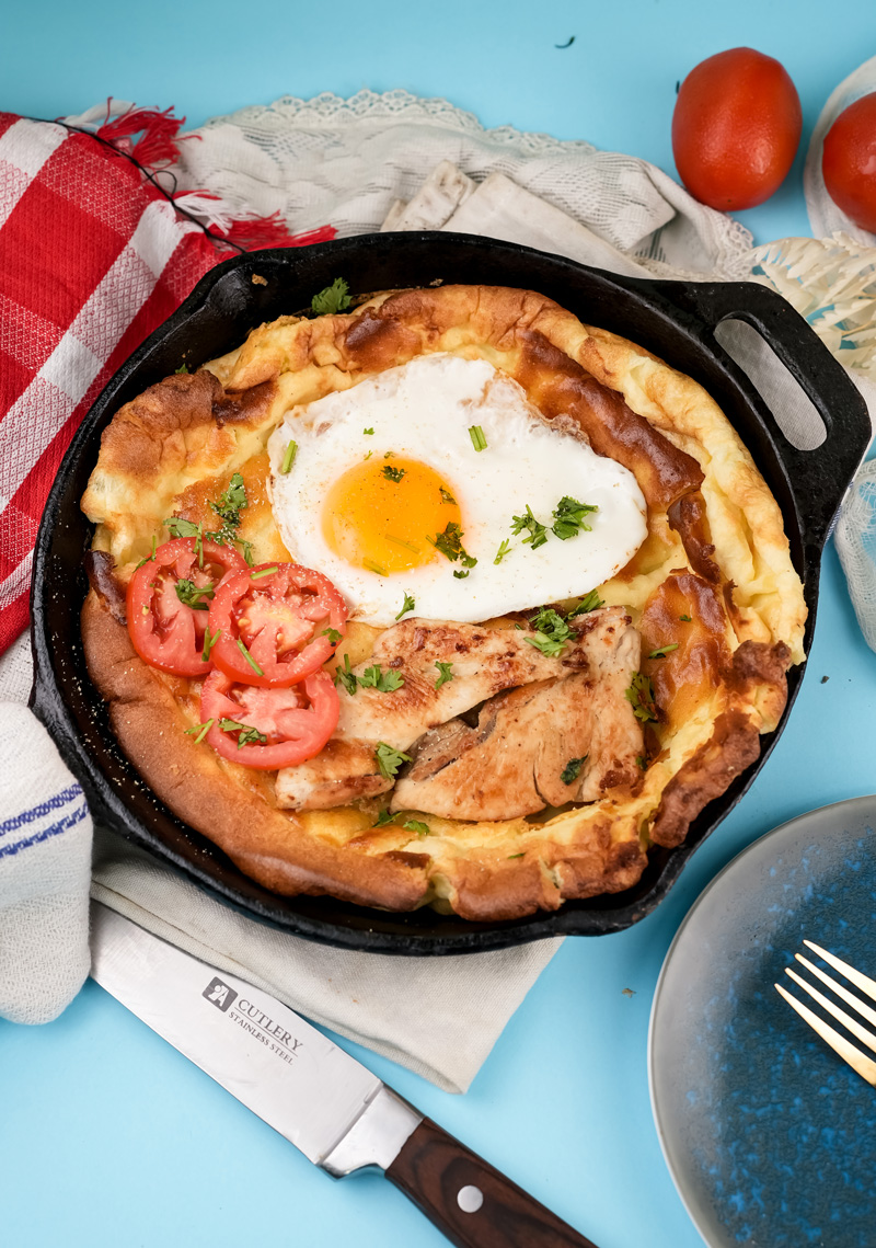 Dutch baby pancake with chicken, egg, tomatoes and fresh herbs