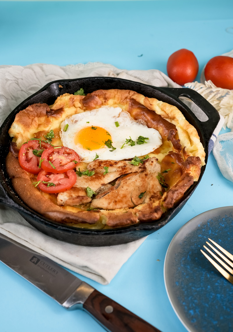 Savory Dutch baby pancake topped with chicken and fried egg
