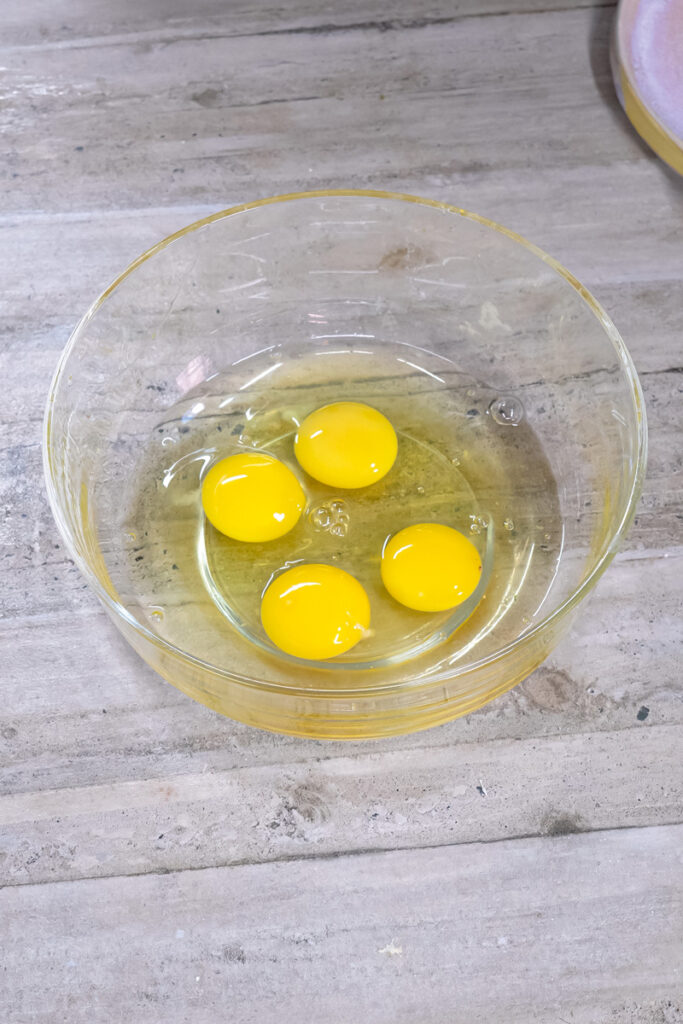 Adding eggs for German pancake recipe