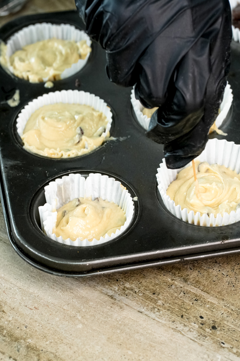 Filling mini muffin cups with chocolate chip batter