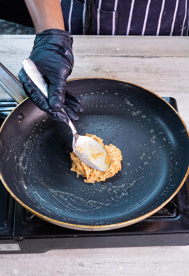 Flipping potato pancake with spatula during cooking