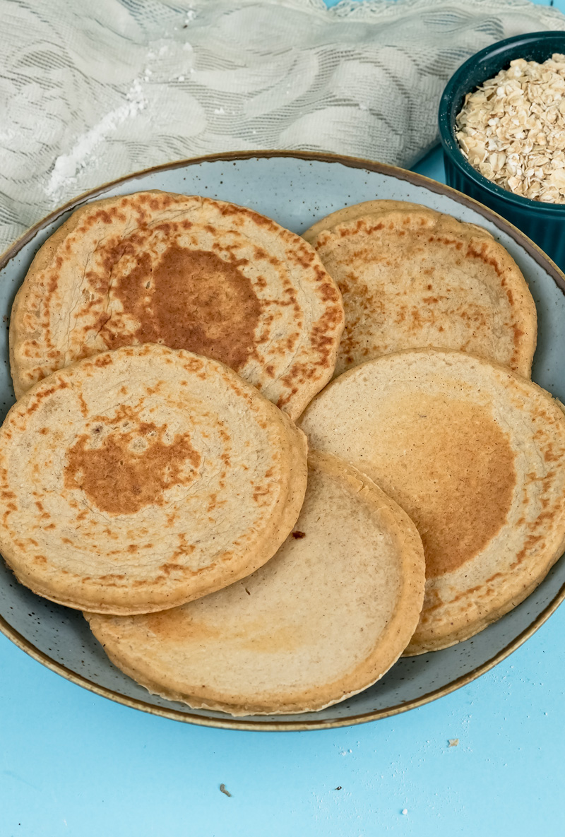 Fluffy oat pancakes breakfast stack on white plate