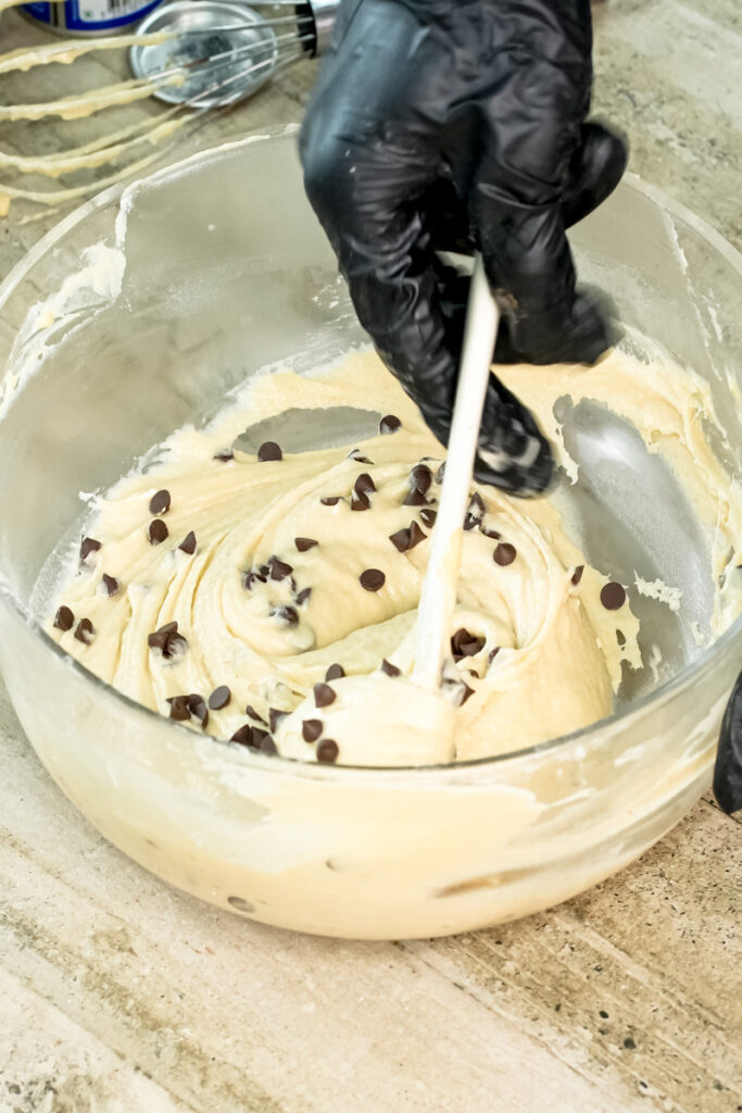 Folding chocolate chips into mini muffin batter