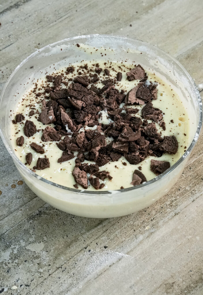 Folding crushed Oreos into pancake batter mixture