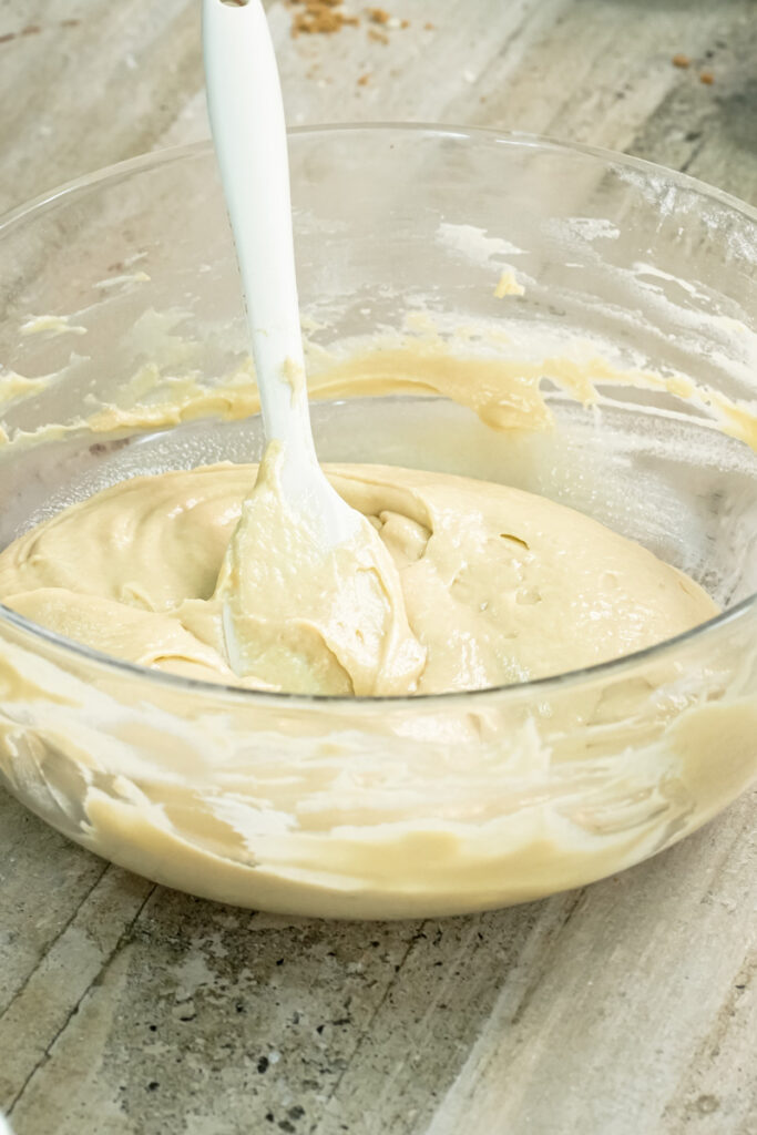 Folding mini chocolate chip muffin batter with spatula