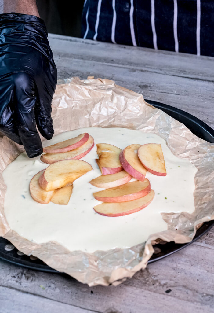 Fresh apple slices arranged on German Apple Pancake batter