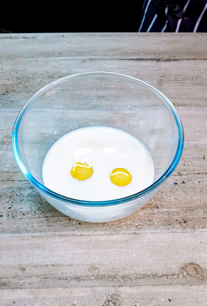 Fresh eggs and milk in mixing bowl for pancake batter