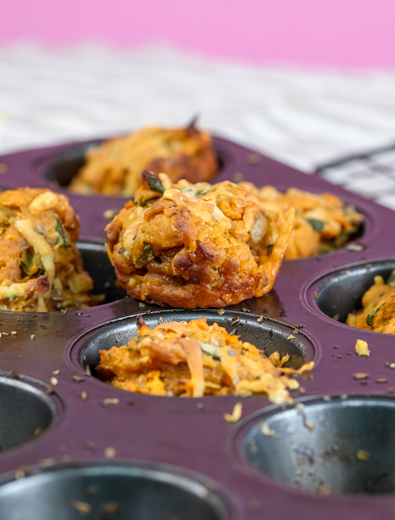 Freshly baked golden pizza muffins in purple muffin tin
