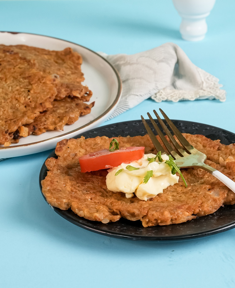 German potato pancake served with sour cream and tomato garnish