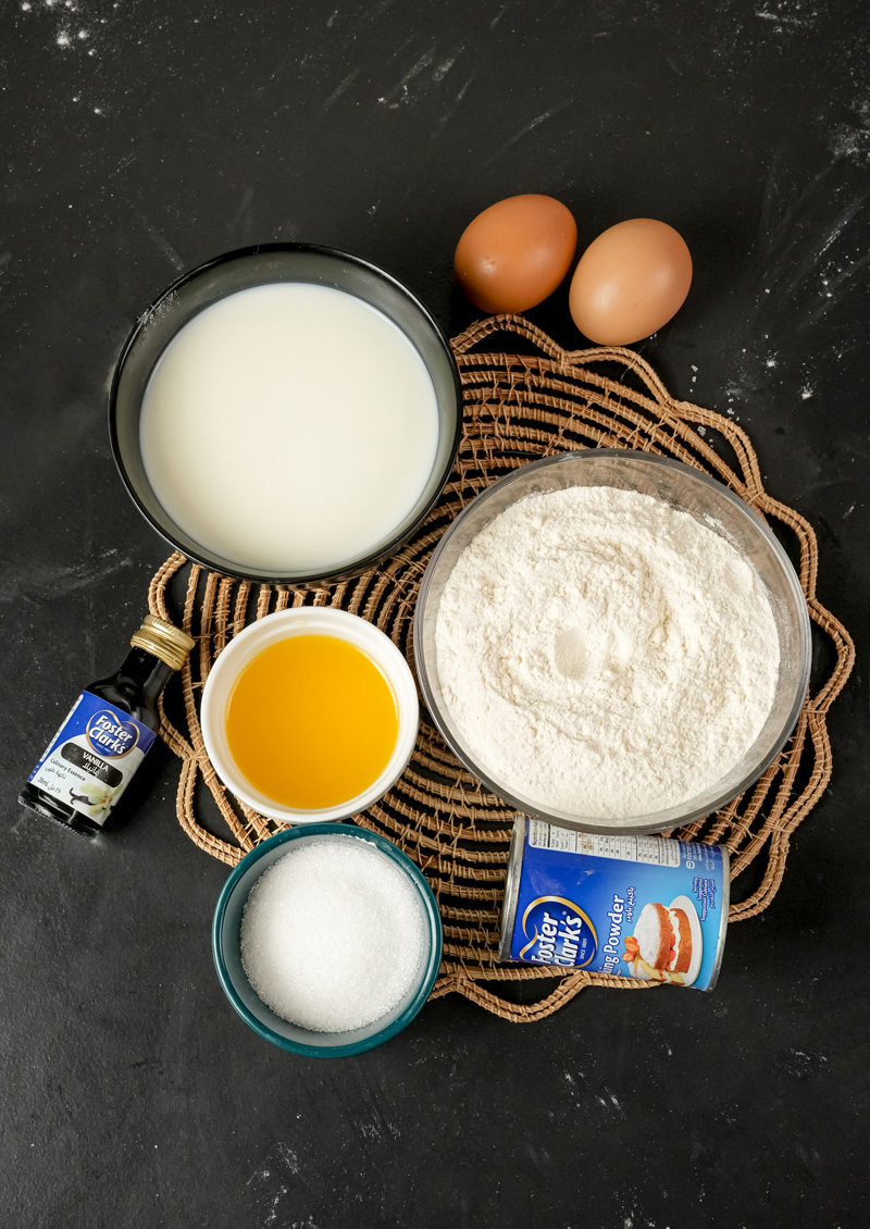 Gluten-free pancake ingredients - flour, milk, eggs, vanilla, sugar, and baking powder