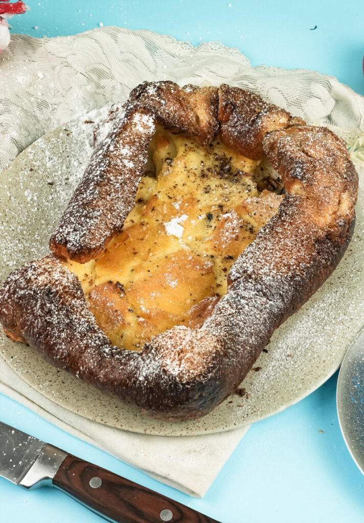 Golden German pancake with powdered sugar ready to serve