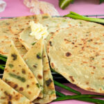 Close-up of golden scallion pancakes showing flaky texture