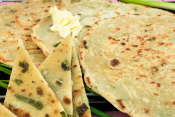 Close-up of golden scallion pancakes showing flaky texture