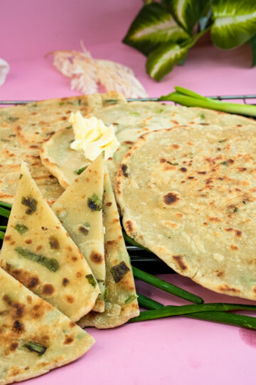 Close-up of golden scallion pancakes showing flaky texture